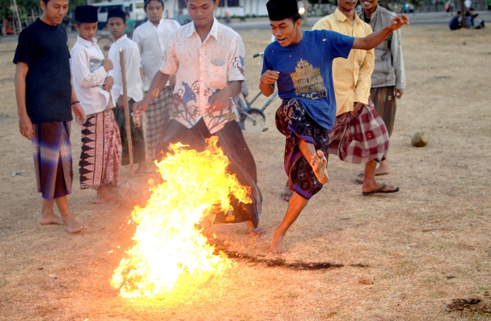 ***EXCLUSIVE*** KEDIRI, INDONESIA - OCTOBER 3: Students play Fire Football at the boarding school Lirboyo on October 3, 2012 in Kediri, Indonesia. THE PREMIER League boasts some of the hottest stars in the world – but they’ve got nothing on these fiery